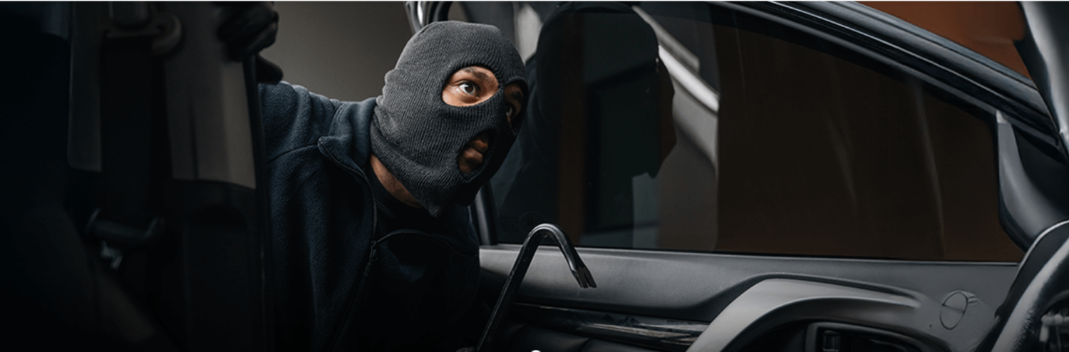 Thief breaking into car