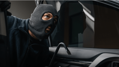 Thief breaking into car